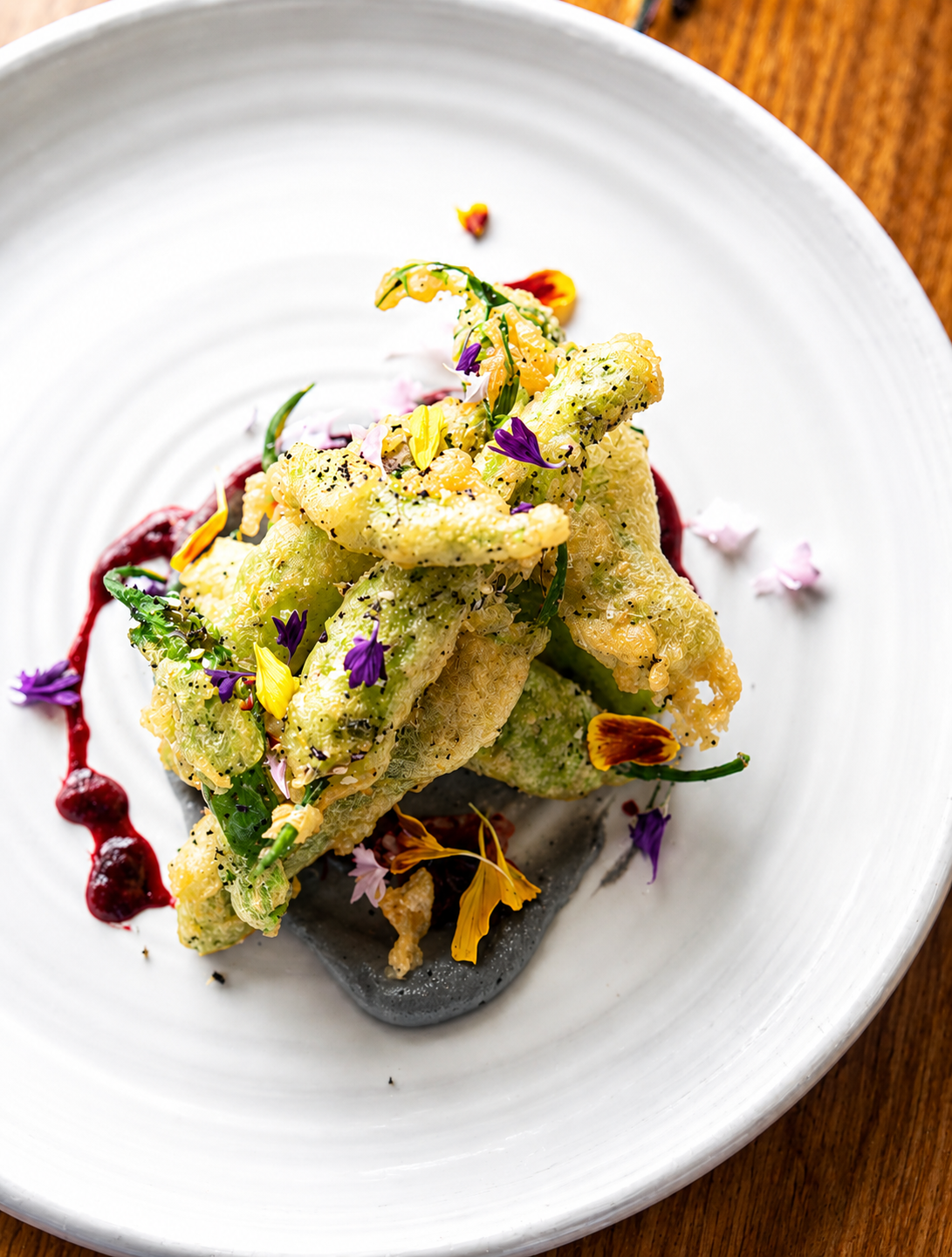 Squash blossom tempura with berry gastrique